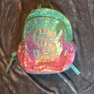 Sequins Justice backpack with initial “S” on it